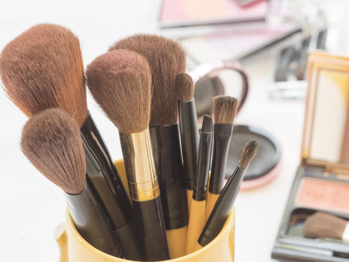 clean makeup brushes in a mug to show proper makeup hygiene
