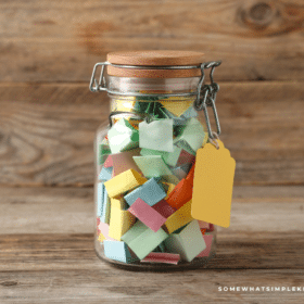 glass tattle jar filled with colorful strips of paper