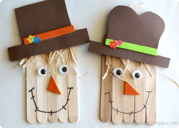 two scarecrow crafts made with popsicle sticks and raffia