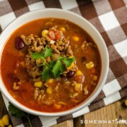 looking down on a bowl of taco soup topped with garnish