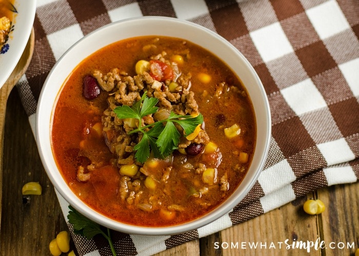 looking down on a bowl of taco soup topped with garnish