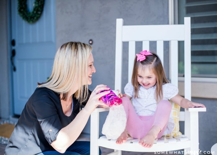 mom and daughter having fun outside with bubbles