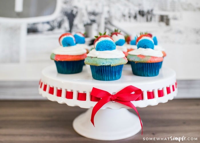 red, white & blue cupcakes on a cake stand