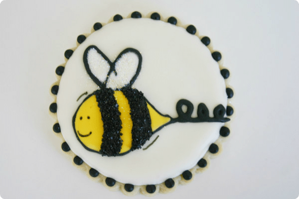 bee cookie using a projector to make the design on the sugar cookie