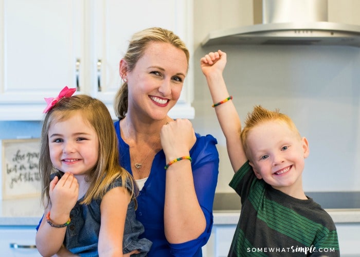 a cute blonde woman with her two children each wearing a colored pasta bracelet