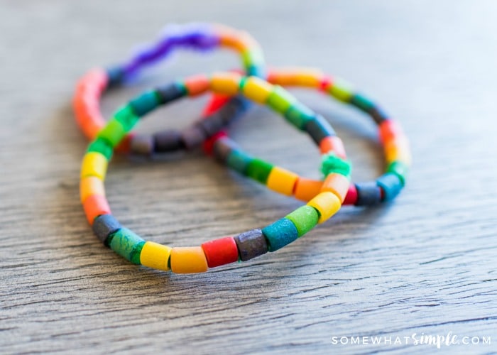 there colored pasta bracelets laying on a table