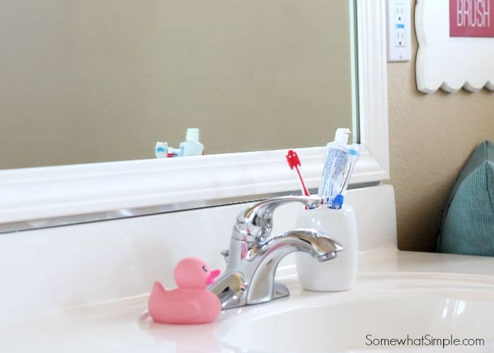 a framed bathroom mirror that had plastic clips