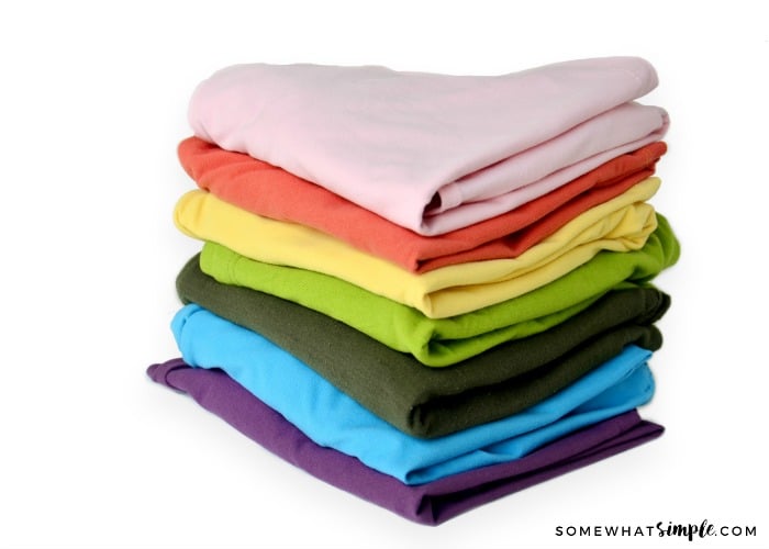 Stack of colorful clothes to show a vinegar cleaning hack.