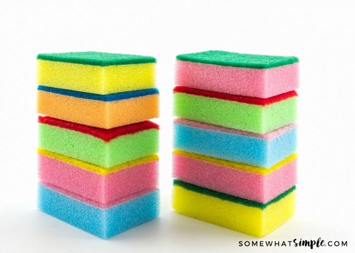 stack of sponges to show a vinegar cleaning hack that can keep sponges smelling fresh