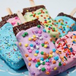a plate of brightly colored popsicle brownies