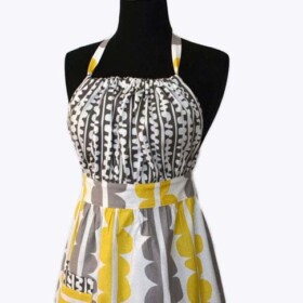 a grey and yellow fabric apron on a mannequin