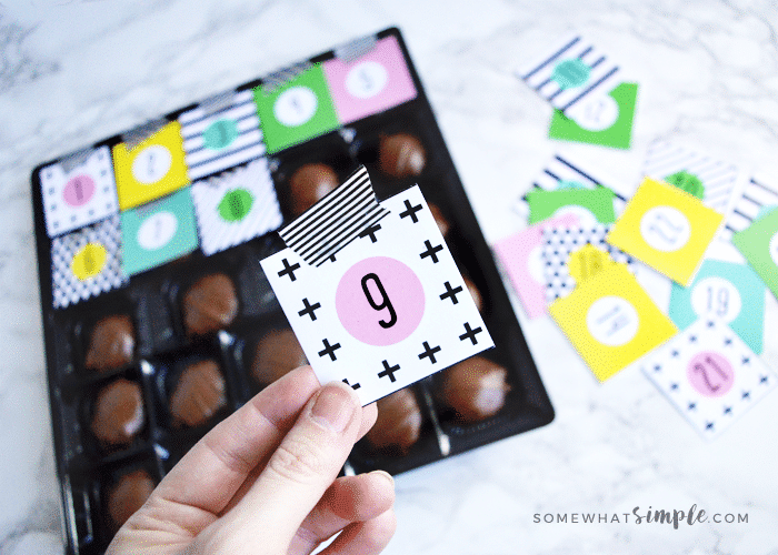 a box of chocolate in the process of becoming a christmas advent calendar using this free printable