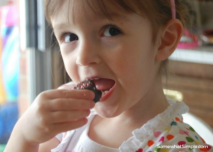 a little girl eating a valetine's smores bite