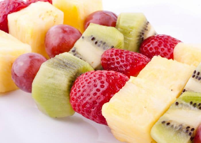 a Fruit Kabob made with strawberries, grapes, kiwi and pineapple