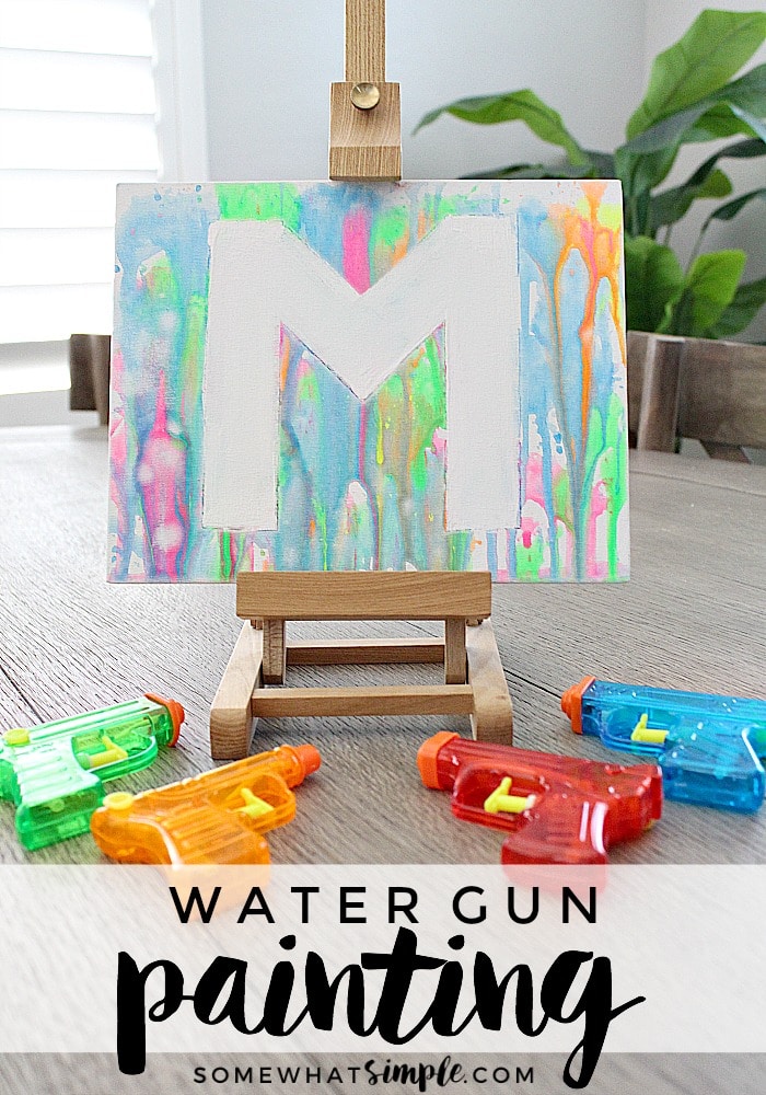 If you're looking for some fun, inexpensive art projects for kids this summer, add painting with water guns to your list! This will keep your kids busy and doing something creative with their time. #watergunpainting #funkidsactivity #paintingactivity #artproject #funprojectforkids via @somewhatsimple