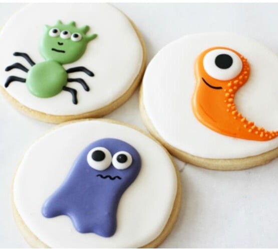 3 sugar cookies with a different monster decorated on each one