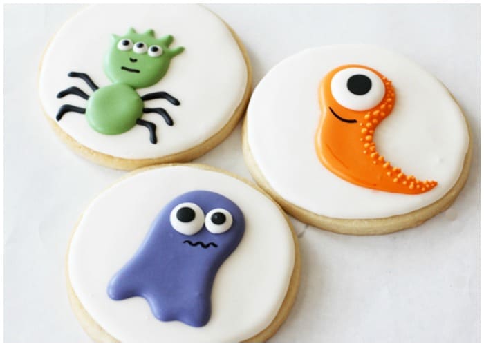 3 sugar cookies with a different monster decorated on each one