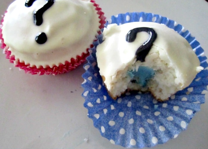 gender reveal cupcakes with white icing and a black question mark on top