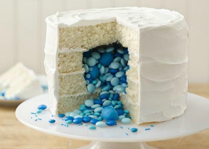 a white cake filled with blue candy is an easy gender reveal idea