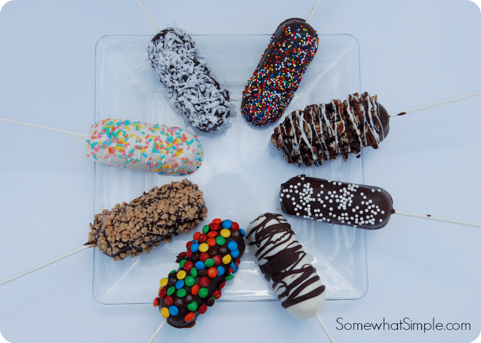 over head view of Chocolate Covered Twinkies in a circle with different toppings on a glass tray