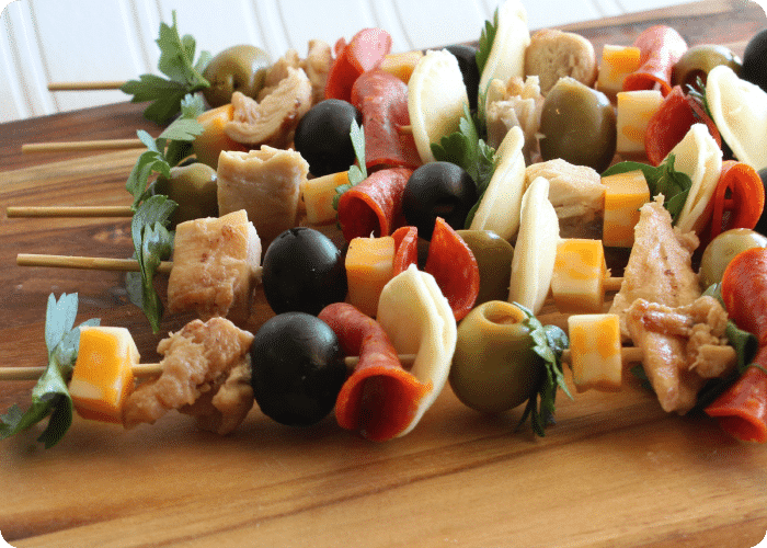 Italian chicken kebobs laying on a wood cutting board is a delicious super bowl snack