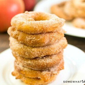 a stack of six cinnamon fried apple rings on a white plate