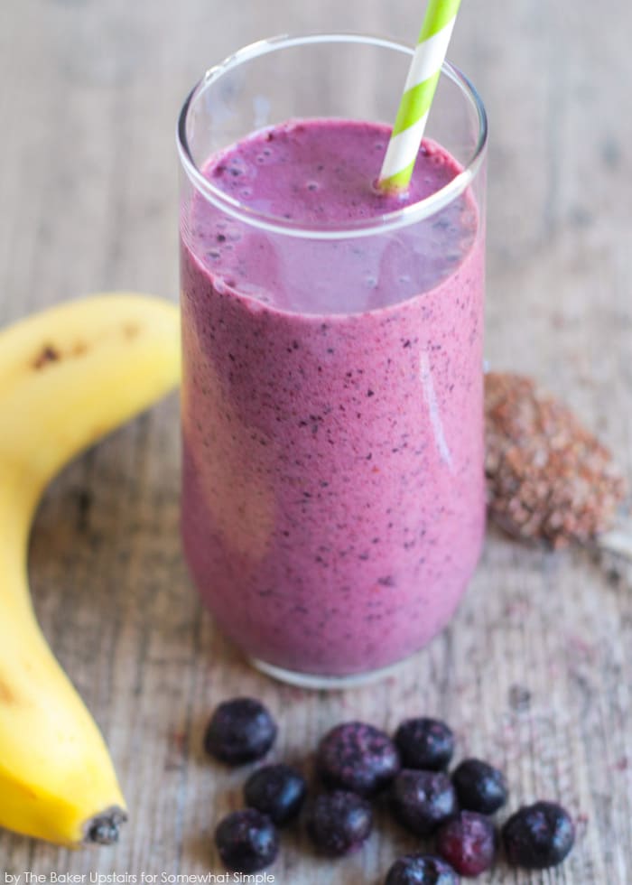 A glass filled with a blueberry pomegranate smoothie 