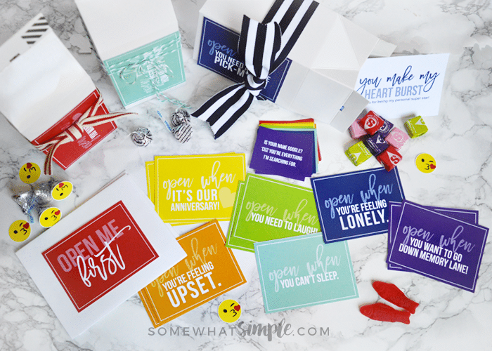 looking down on several brightly colored cards and envelopes that are included in this open when letter printable pack