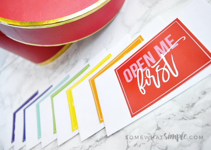 envelopes fanned out on top of a counter. The top card is red and says open me first 