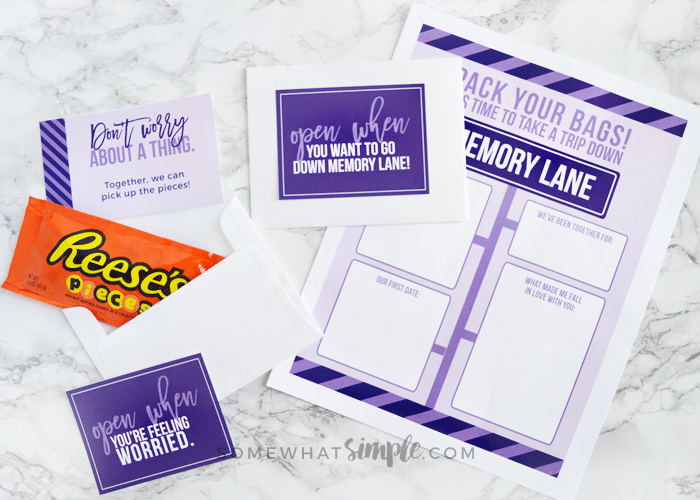 a page from this open when letter printable kit, along with it's card and envelope laying on a counter with a bag of candy next to it