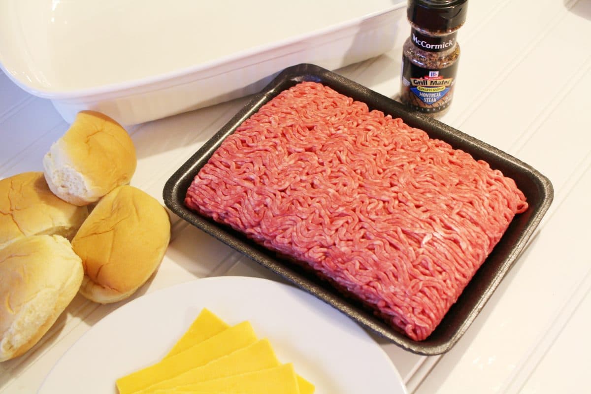 a plate of cheese, ground beef, steak seasoning and slider rolls are the ingredients you need to make oven baked sliders