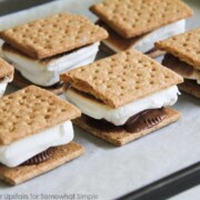 a baking sheet filled will oven baked S'mores that were made inside