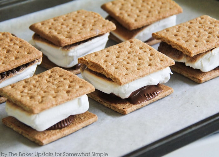 a baking sheet filled will oven baked S'mores that were made inside