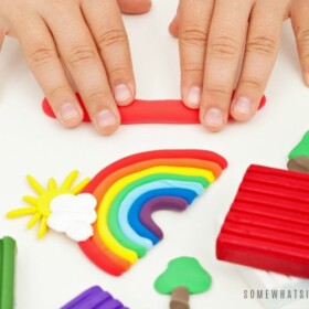 Child hands playing with colorful modeling clay