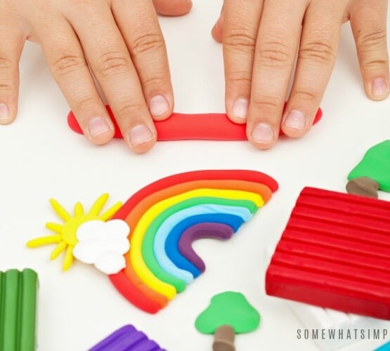 Child hands playing with colorful modeling clay