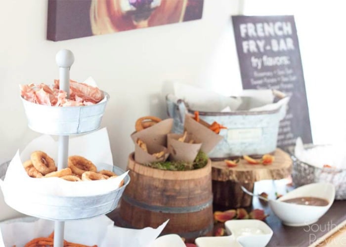 French fry bar set up on a table is a fun idea to display your side dishes at a summer bbq