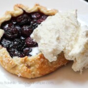 a Blueberry Galette on a plate topped with a scoop of vanilla ice cream