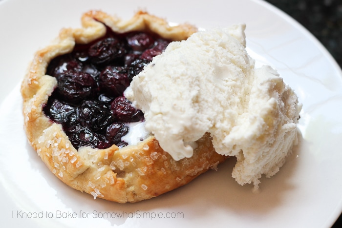 a Blueberry Galette on a plate topped with a scoop of vanilla ice cream