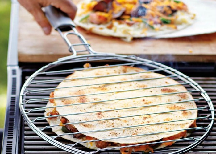 a Grilled Quesadilla in a cooking rack over a camping grill