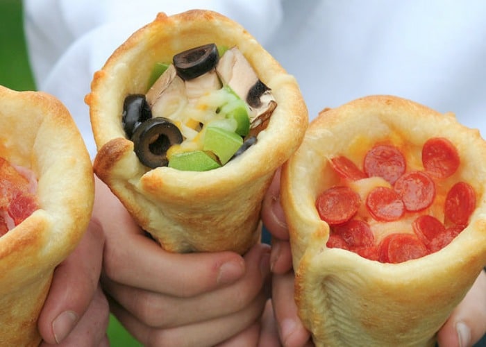 hands holding three Pizza Cones which are a quick and delicious camping meal to make for lunch