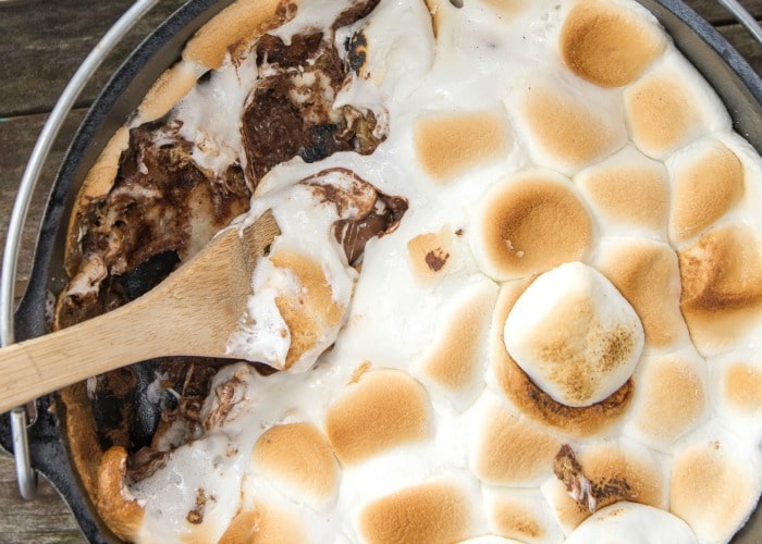 looking down on a Smores Cake with a wooden spoon inside which is an easy camping dessert 