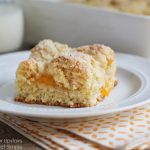 a piece of Peach Streusel Coffee Cake on a white plate