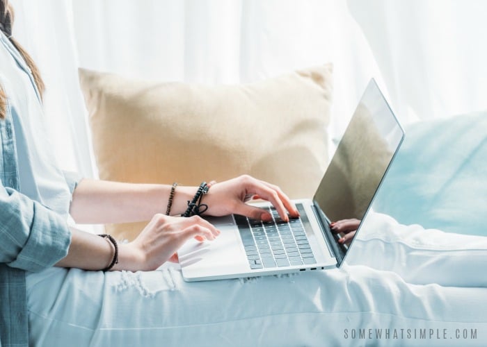 woman sitting in bed with a laptop on her lap