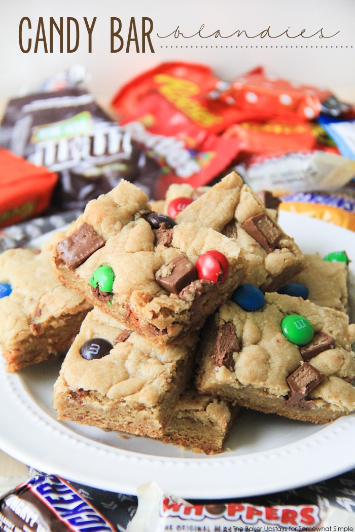 Candy Bar Blondies are a fun twist on a favorite dessert. The deliciously chewy brownie dough gets stuffed and topped with your favorite candies. It's a simple, sweet, and chocolatey treat! via @somewhatsimple