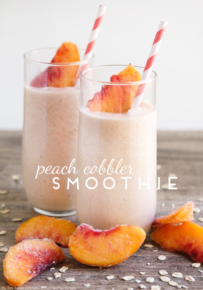 Easy peach smoothie recipe in a tall glass with peaches on the table.