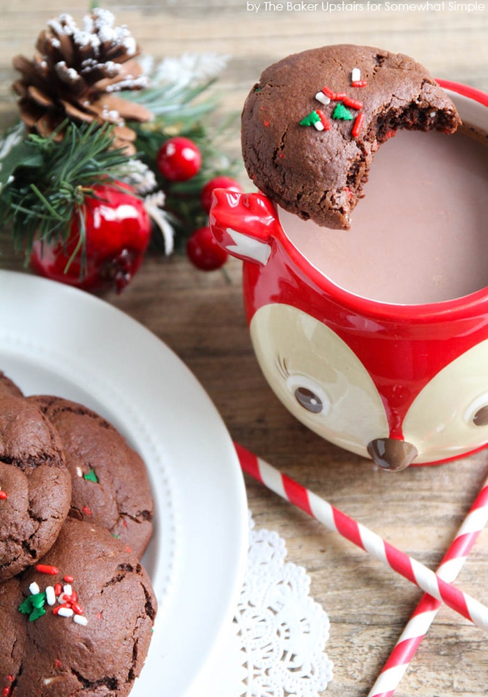 Christmas Funfetti Chocolate Sugar Cookies sitting on top of a mug of hot chocolate