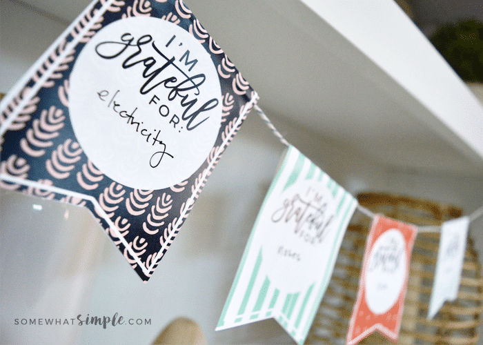 a gratitude garland thanksgiving craft hanging on a shelf