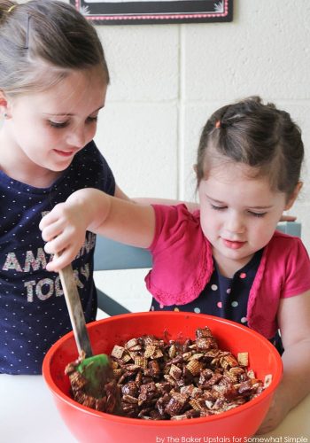 stirring chex cereal with chocolate and peanut butter in a bowl