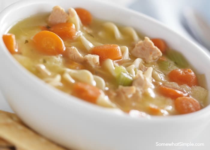 white bowl filled with homemade creamy chicken noodle soup recipe made with delicious chicken and noodles