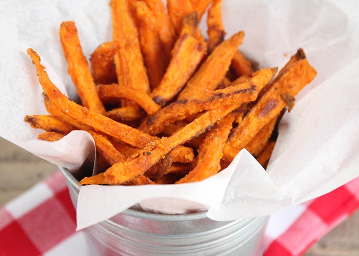 a metal bowl filled with crispy Sweet Potato Fries that were baked in the oven